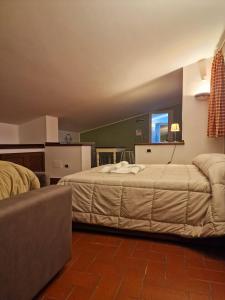 a hotel room with two beds and a couch at DOMUS SAN CARLO LOFT in Caserta