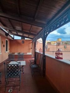 a patio with a table and chairs on a balcony at DOMUS SAN CARLO LOFT in Caserta