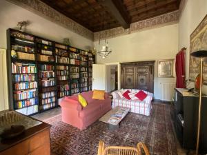 a living room with a couch and book shelves at Palazzo Ronchelli in Castello Cabiaglio