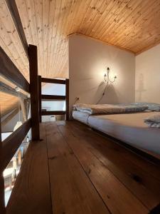 a bedroom with a bed and a wooden ceiling at Apartments Cederika in Věžovatá Pláně