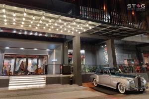 an old car parked in front of a building at STEG Kuala Lumpur in Kuala Lumpur