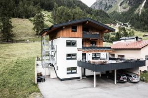 una grande casa bianca con tetto in legno di Apart GuetGeanLossn a Längenfeld