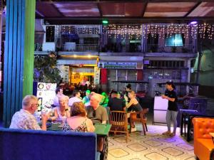 a group of people sitting at a restaurant at Moonlight Villa in Phnom Penh