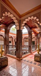 an ornate room with a balcony in a building at Hotel Riad Fantasia in Marrakech
