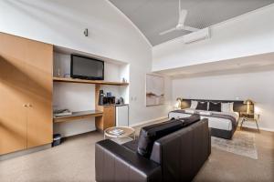 a living room with a bed and a couch at 107 Apartments Margaret River in Margaret River Town