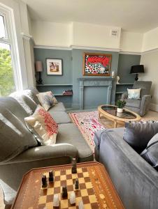 a living room with a couch and chessboard at Artypophouse Unique home to create unique memories in Bersted
