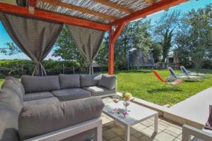 a living room with a couch and a table at Villa Simac With Pool and Whirlpool - Happy Rentals in Pazin