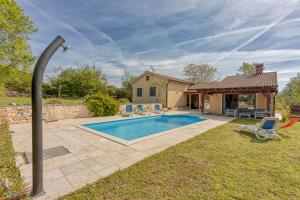 a backyard with a swimming pool and a house at Villa Simac With Pool and Whirlpool - Happy Rentals in Pazin