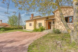 a house with a tree in front of a driveway at Villa Simac With Pool and Whirlpool - Happy Rentals in Pazin