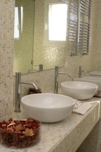 a bathroom with two white sinks on a counter at Suite Luxury Seaview in Misano Adriatico