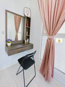 a chair in front of a window with a mirror at HoneyMoon Suites @ Sutera Avenue Kota Kinabalu Sabah Malaysia in Kota Kinabalu +58 photos