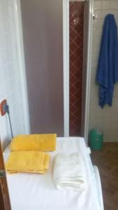 a bathroom with two towels sitting on a counter at Il mare cristallino dell'Ogliastra- Marina di Tertenia in Tertenìa