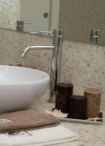 a bathroom counter with a sink and a mirror at Suite Luxury Seaview in Misano Adriatico