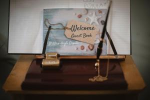 a close up of a welcome guest book on a table at Villa Valentina Versilia in Viareggio +37 photos
