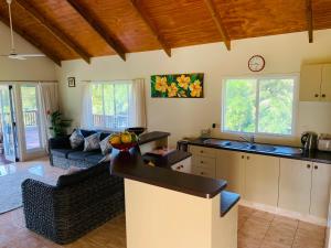 a kitchen and living room with a counter top at Muri Villas in Rarotonga