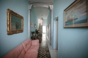a hallway with a couch and a painting on the wall at Villa Valentina Versilia in Viareggio