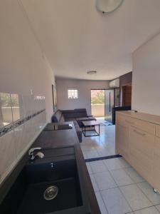 a large kitchen with a sink in the middle at Apartments Miranda in Kaprije