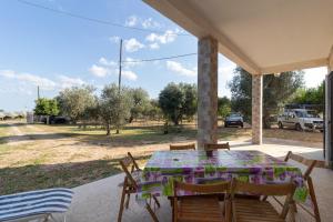 a table and chairs on the porch of a house at Villa Maria in Castellaneta