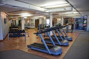 a gym with several treadmills and machines at Mövenpick Hotel Windhoek in Windhoek