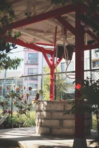 a pavilion with a bird sitting under it at Kamagasaki University of the Arts Cafe Garden Guest House aka Cocoroom in Osaka