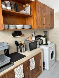 a kitchen with a microwave oven and a stove at Villa 471 m2 sur la plage in Mohammedia