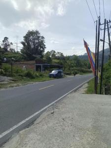 a car is parked on the side of a road at Pudan Residence Parapat By Helocus in Parapat