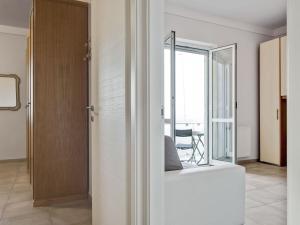 a white room with a sliding door and a window at Amazing holiday home near pet friendly beach in Carrara