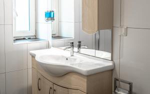 a bathroom with a white sink and a mirror at Central Apartments Vienna - CAV in Vienna