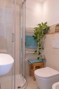 a bathroom with a shower and a toilet and a sink at VITEDIMARE APARTMENT SOLE - SUN in Muggia