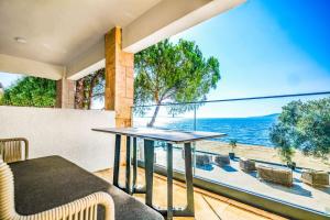 a table and chairs on a balcony with a view of the ocean at İsolina Bodrum in Bodrum City