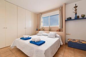ein Schlafzimmer mit 2 Betten und blauen Handtüchern darauf in der Unterkunft Ca Martin in Pedreguer