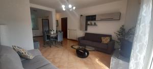 a living room with a couch and a table at IL TULIPANO in Civitavecchia