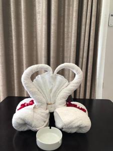 a pair of towels sitting on top of a table at The Voice Hotel in Entebbe