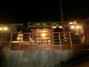 a building at night with a fence and lights at Shirahama Meiji Villa in Shirahama