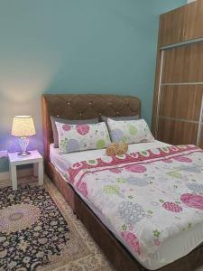 a bedroom with a bed with a teddy bear on it at ER Homestay 2R1B suite nearby KLIA Terminal in Sepang