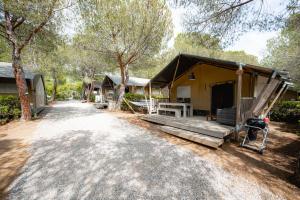 a house with a dirt road in front of it at Glamping at Elba in Lacona