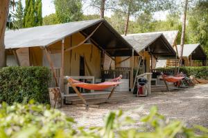 a group of tents with hammocks in them at Glamping at Elba in Lacona