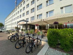 a group of bikes parked in front of a building at Jantar Resort in Szczecin