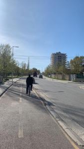 a person riding a bike down the street at Arlind's Apartaments in Vlorë