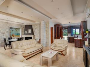 a living room with two couches and a fireplace at Summer Dream Villas in Hersonissos