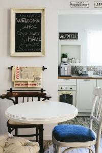 a kitchen with a white table and two chairs at 5 Vintage Guest House in Sofia