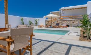 a villa with a swimming pool and a house at Petradia Villas in Naxos Chora