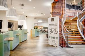 a bicycle shop with a staircase in a room at Dorint City-Hotel Bremen in Bremen