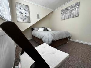 a bedroom with a bed and a chair in it at SILVERDALE HOUSE in Southend-on-Sea