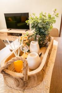 una mesa con una bandeja de madera con una vela y plantas en Sweet Home Houses 1, en Kalamata