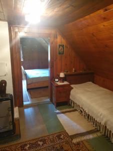 a bedroom with a bed and a mirror in a room at Almzeithütte am Seeberg 