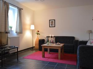 a living room with a couch and a table with candles at A modern holiday home by the River Mosel in Moselkern