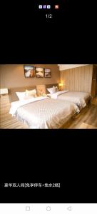a bedroom with a large white bed and two pictures at Morninginn, Lianyuan Furong Plaza in Lianyuan