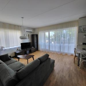 a living room with a couch and a table at Kastani Home in Tartu