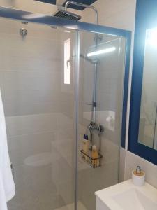 a bathroom with a glass shower with a sink at Pozo De Las Nieves in Orgaz